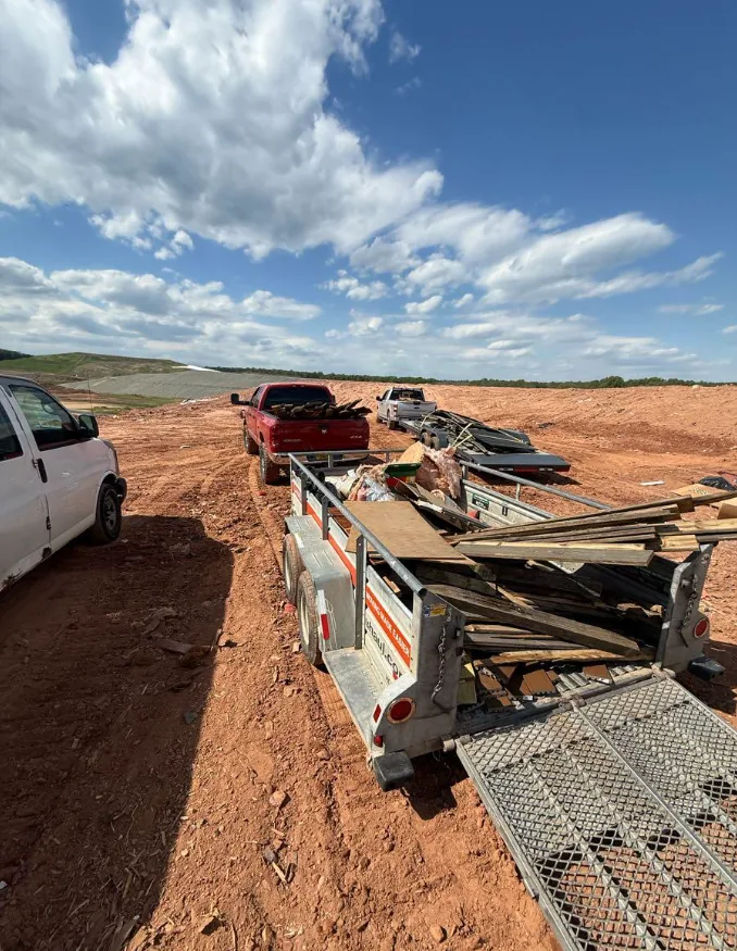 Trailer full of demo lumber and scrap being unloaded at the landfill
