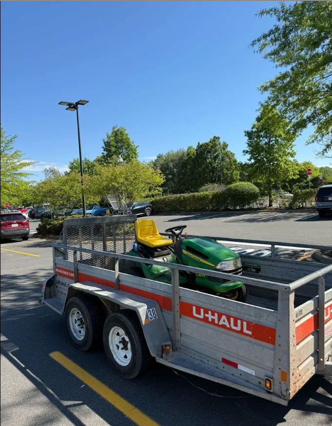Riding mower loaded on a trailer for pickup and delivery across Loudoun County